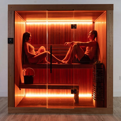Two people seated on the benches inside the CT Element Studio, seen through the glass front