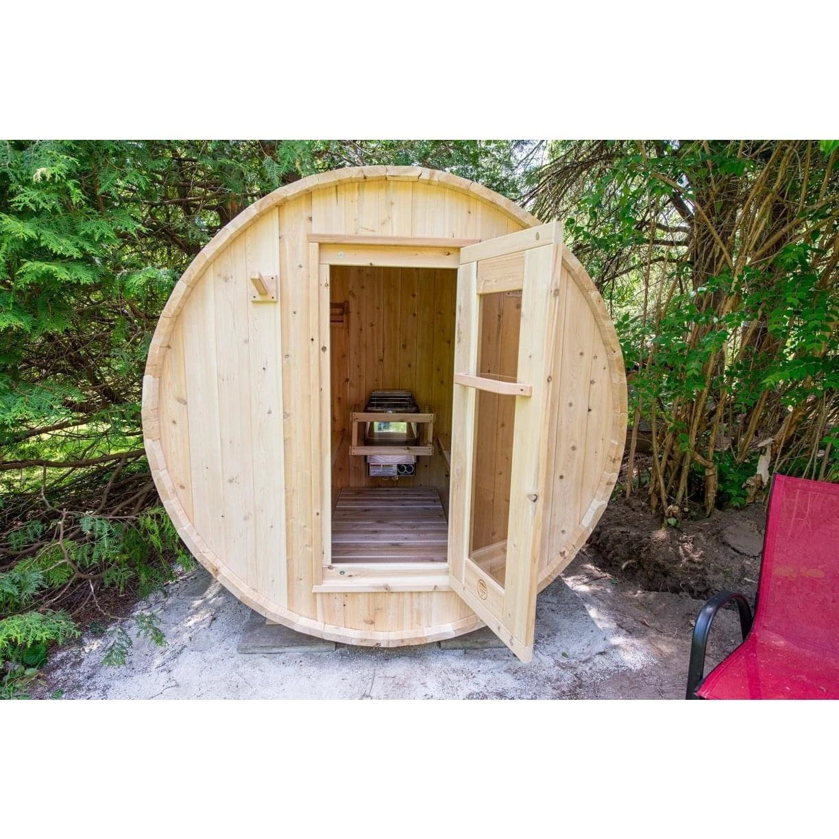 CT Harmony barrel sauna with the cedar door open, looking through to the benches inside
