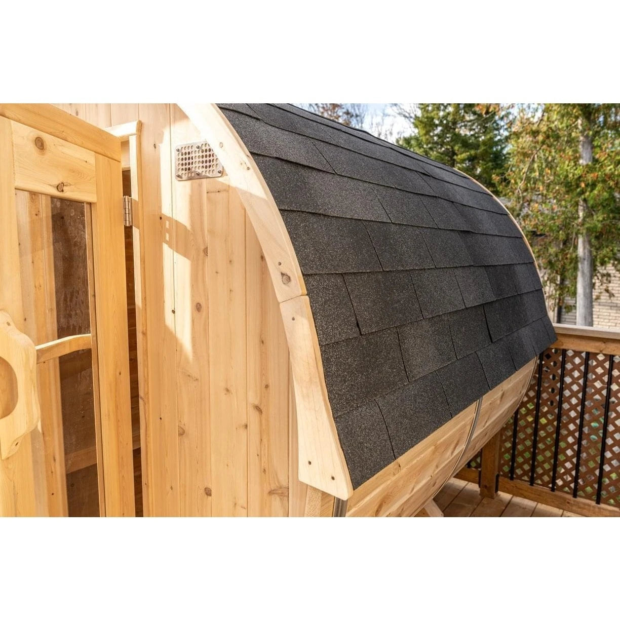 CT Harmony barrel sauna fitted with the optional asphalt shingle roof, on a deck