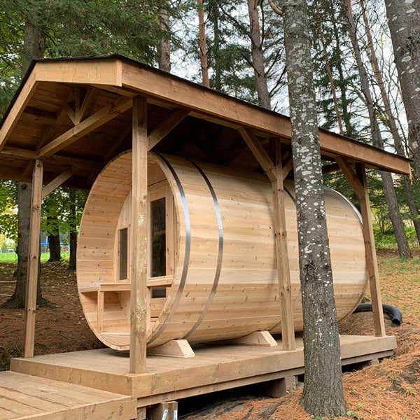CT Tranquility barrel sauna set under a timber pergola in woodland