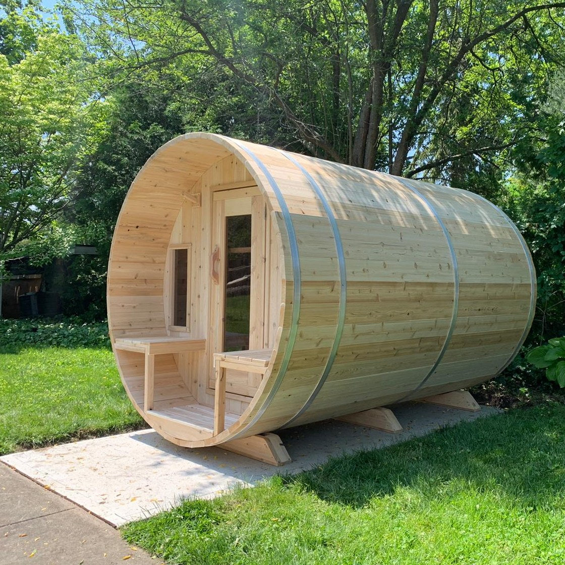 CT Tranquility barrel sauna on a lawn beside a paved path