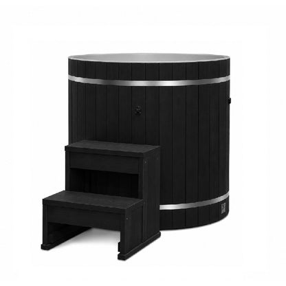 Dynamic Cold Therapy Black Barrel Cold Plunge Tub (Plastic Interior), three quarter view of the black synthetic wood exterior with the two tier entry step