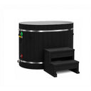 Dynamic Cold Therapy Black Oval Barrel Cold Plunge Tub, side view of the black synthetic wood exterior with the two tier entry step and the inlet and outlet fittings