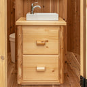 Two drawer pine glamping vanity with a clear coat finish inside a LeisureCraft Skylight
