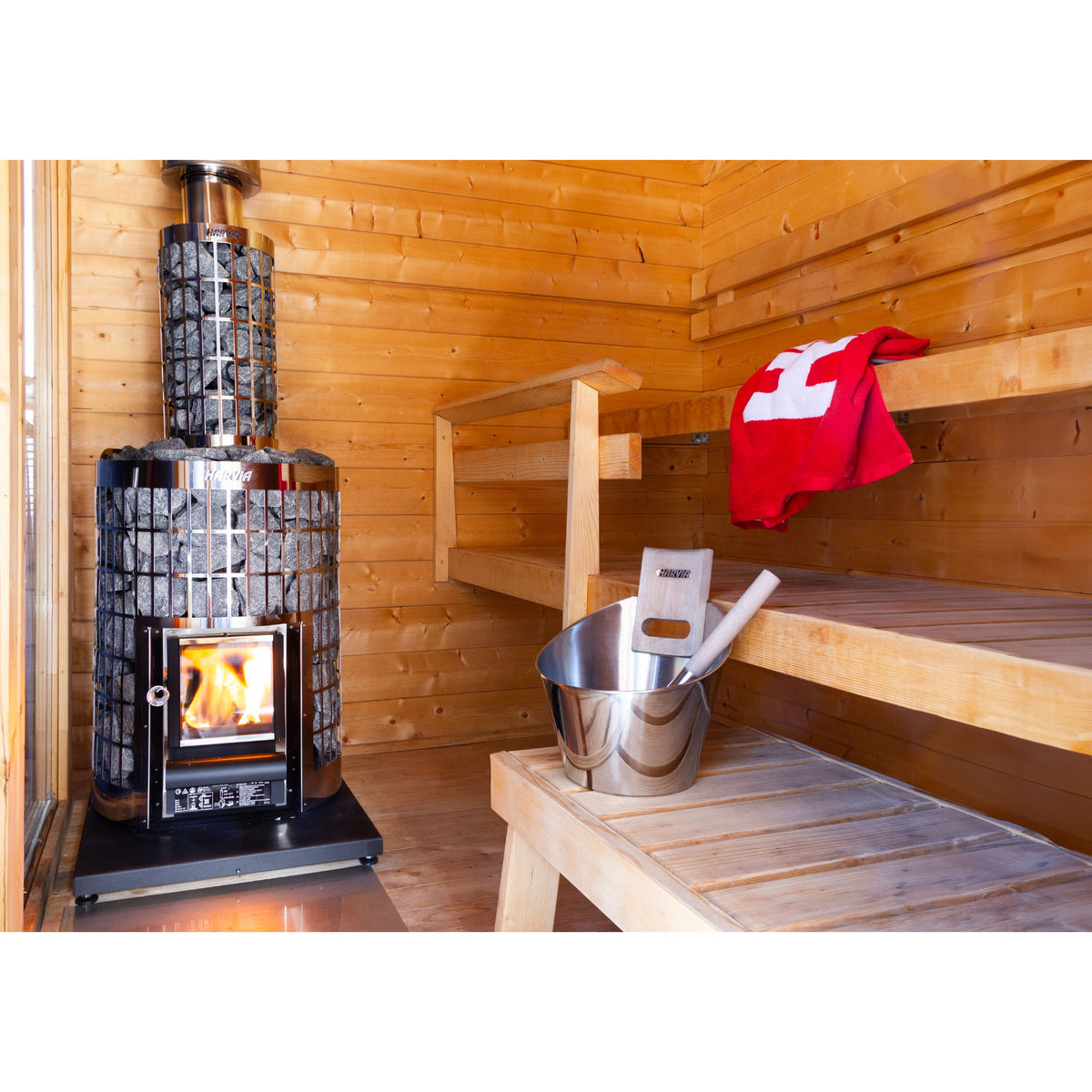 Harvia Cilindro 16 16kW in a timber sauna with a bucket and red towel on the bench