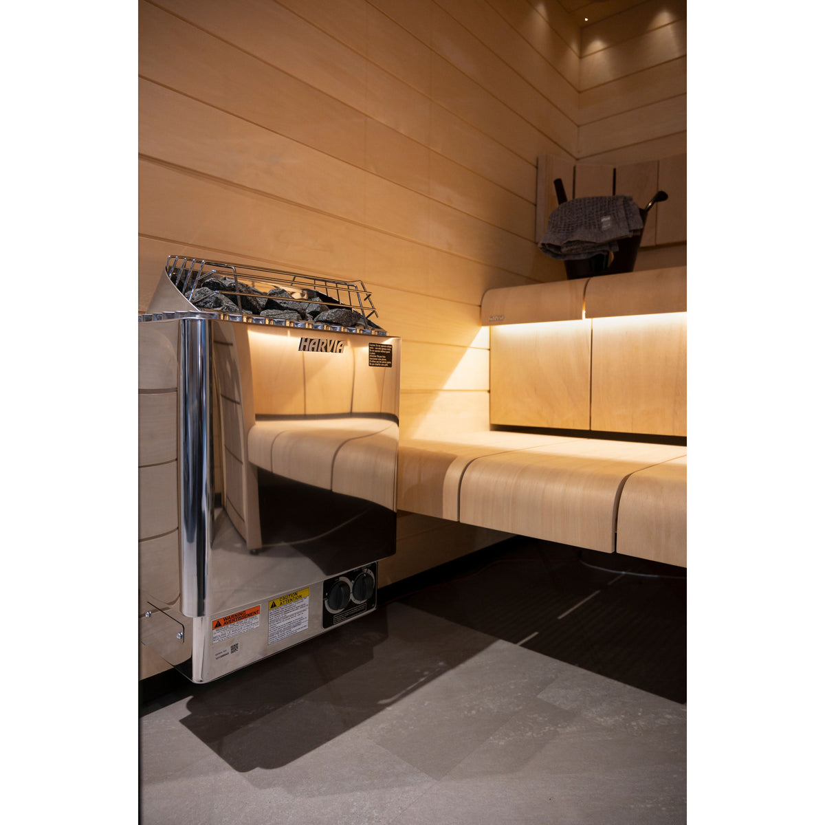Harvia KIP45B 4.5kW in stainless steel installed in a sauna corner beside the benches