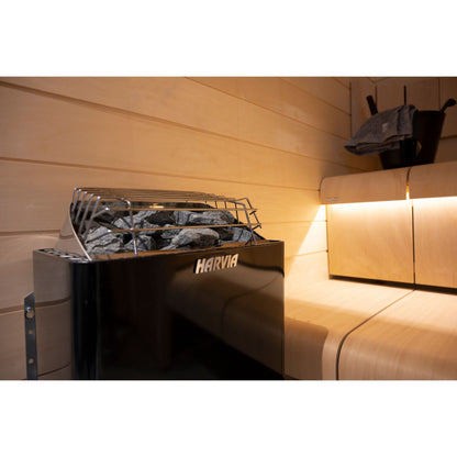 Harvia KIP60B 6kW in graphite black beside the sauna bench