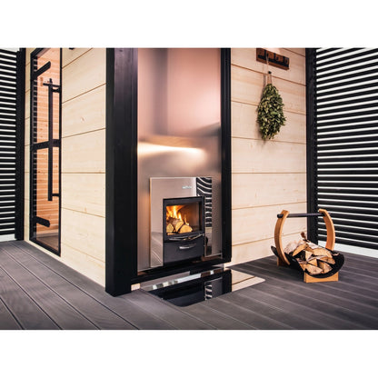 Harvia Pro 20 Duo fire door set into a wall beside a firewood holder, heating the sauna on the other side