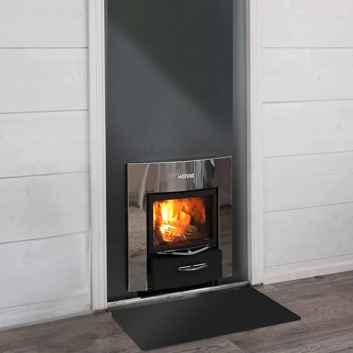 Harvia Pro 20 Duo fire door and glass window set into a dark wall panel, with a floor protection plate in front