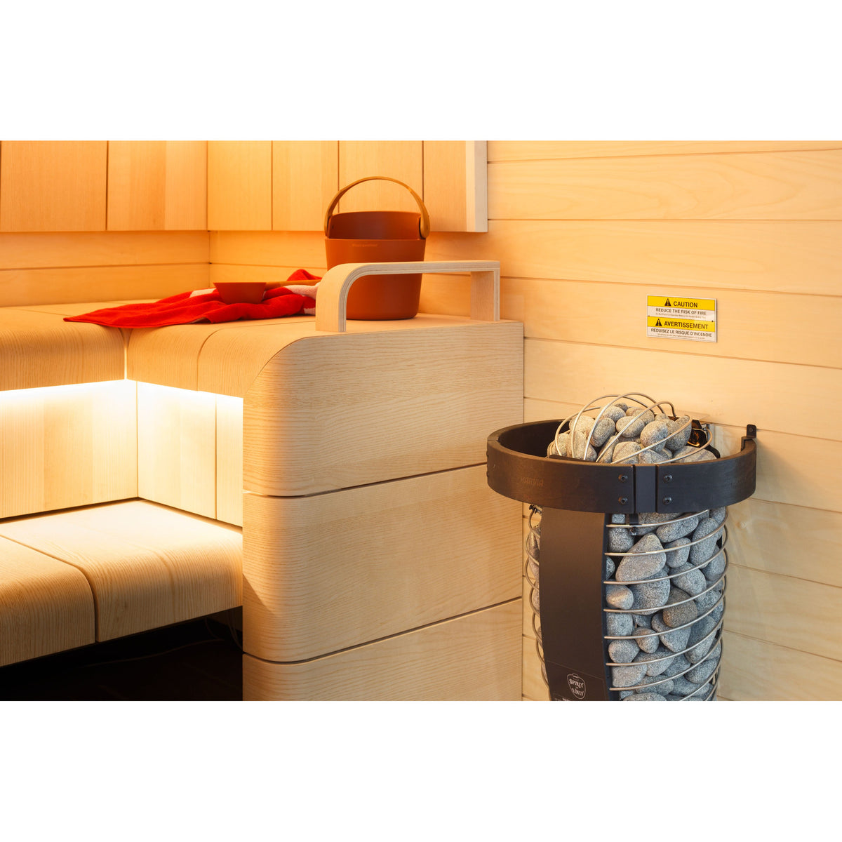 Harvia Spirit SP60E 6kW beside the sauna bench under warm lighting