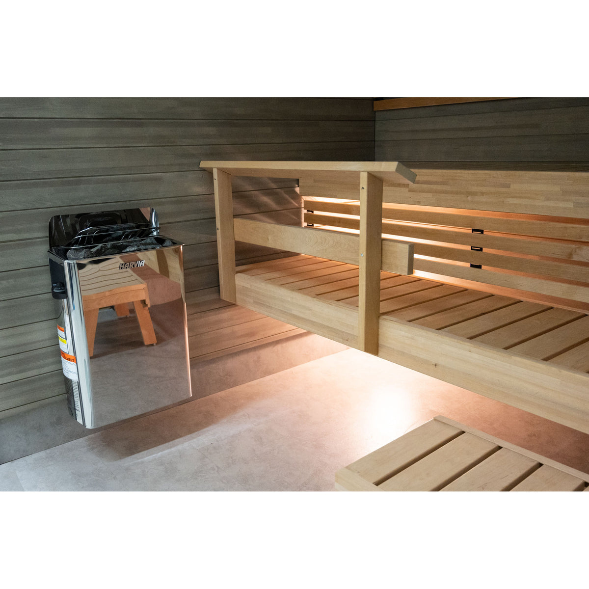 Harvia The Wall SW60 6kW installed beside a timber bench in a finished sauna