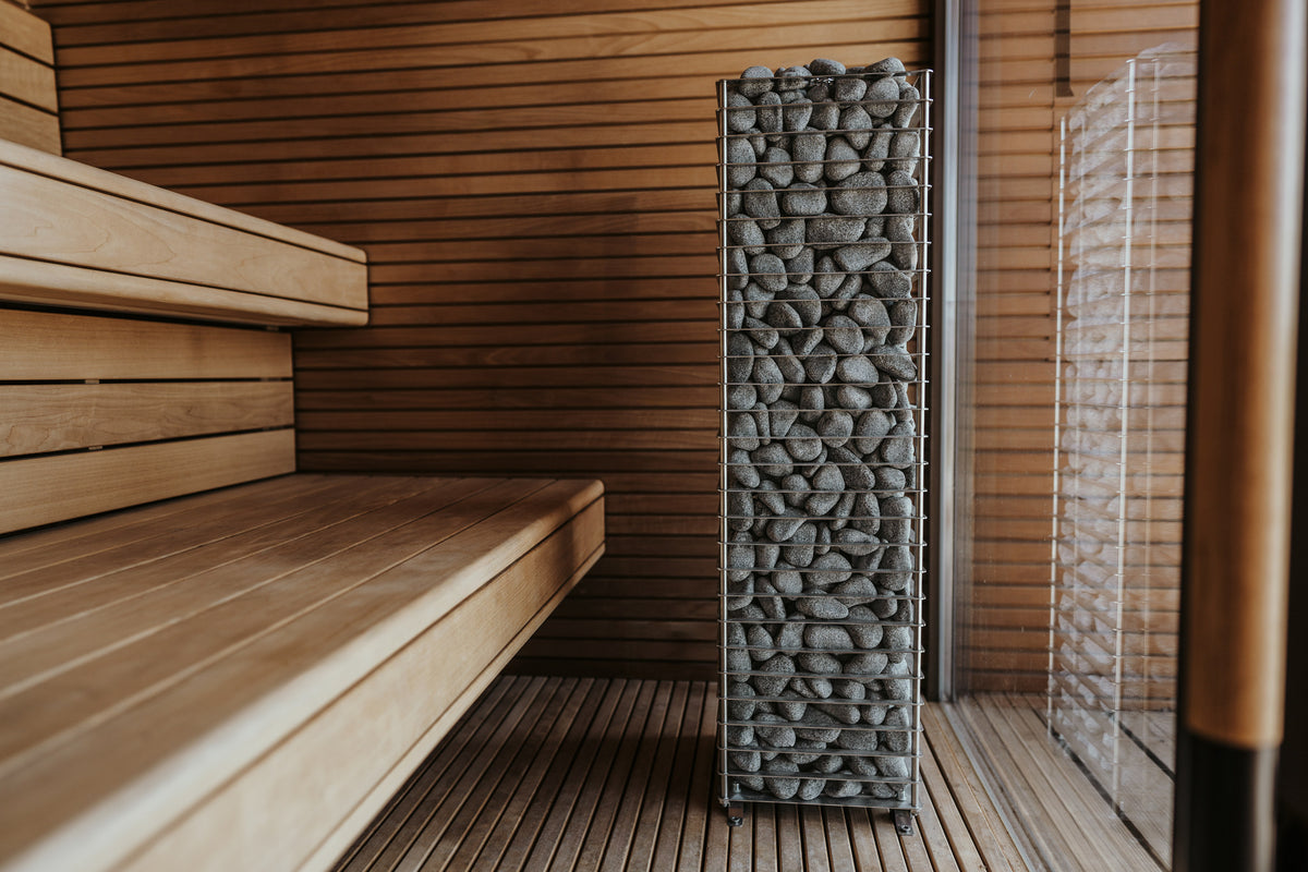 HUUM CLIFF heater in a sauna beside the benches