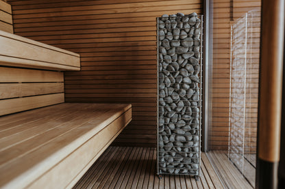 HUUM CLIFF heater in a sauna beside the benches