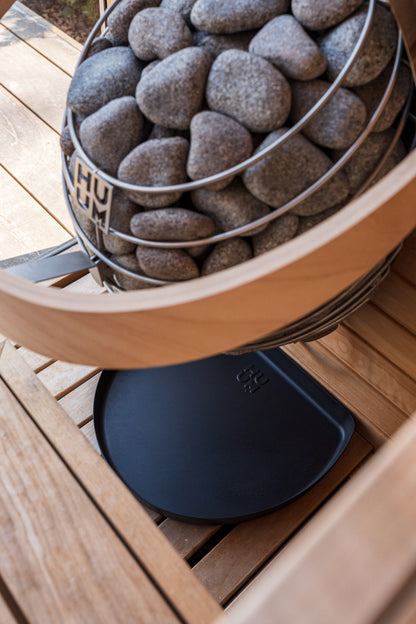 HUUM DROP heater on a bench over the black drip tray