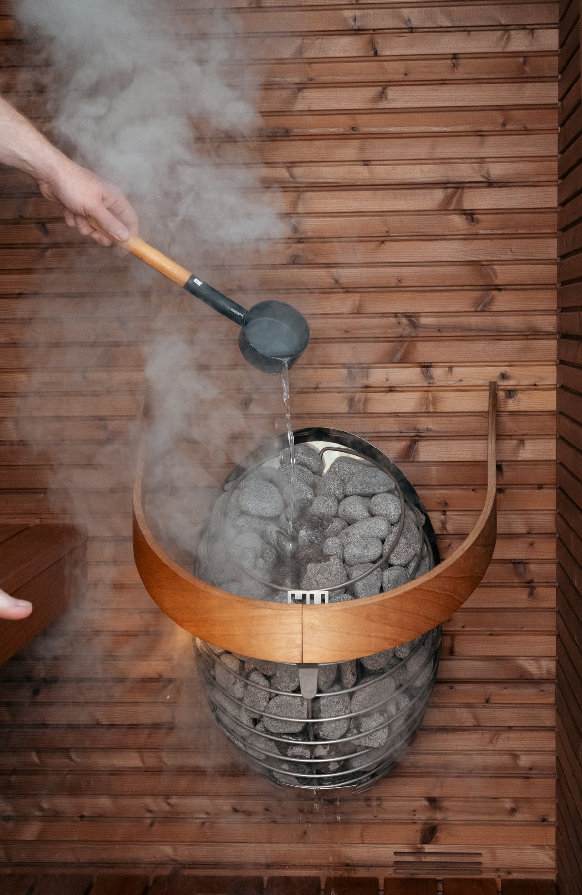 Water ladled onto a HUUM DROP heater fitted with the safety rail