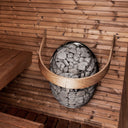 HUUM Drop heater with the wooden safety railing fitted around the stone cage