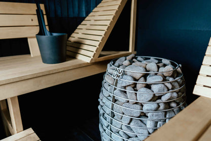 HUUM HIVE heater in a sauna with a dark wall