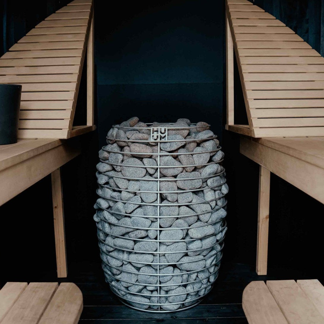 HUUM HIVE 12 sauna heater between sauna benches