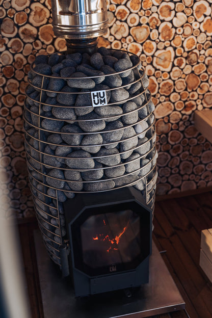 HUUM HIVE Flow sauna stove in a wood lined sauna