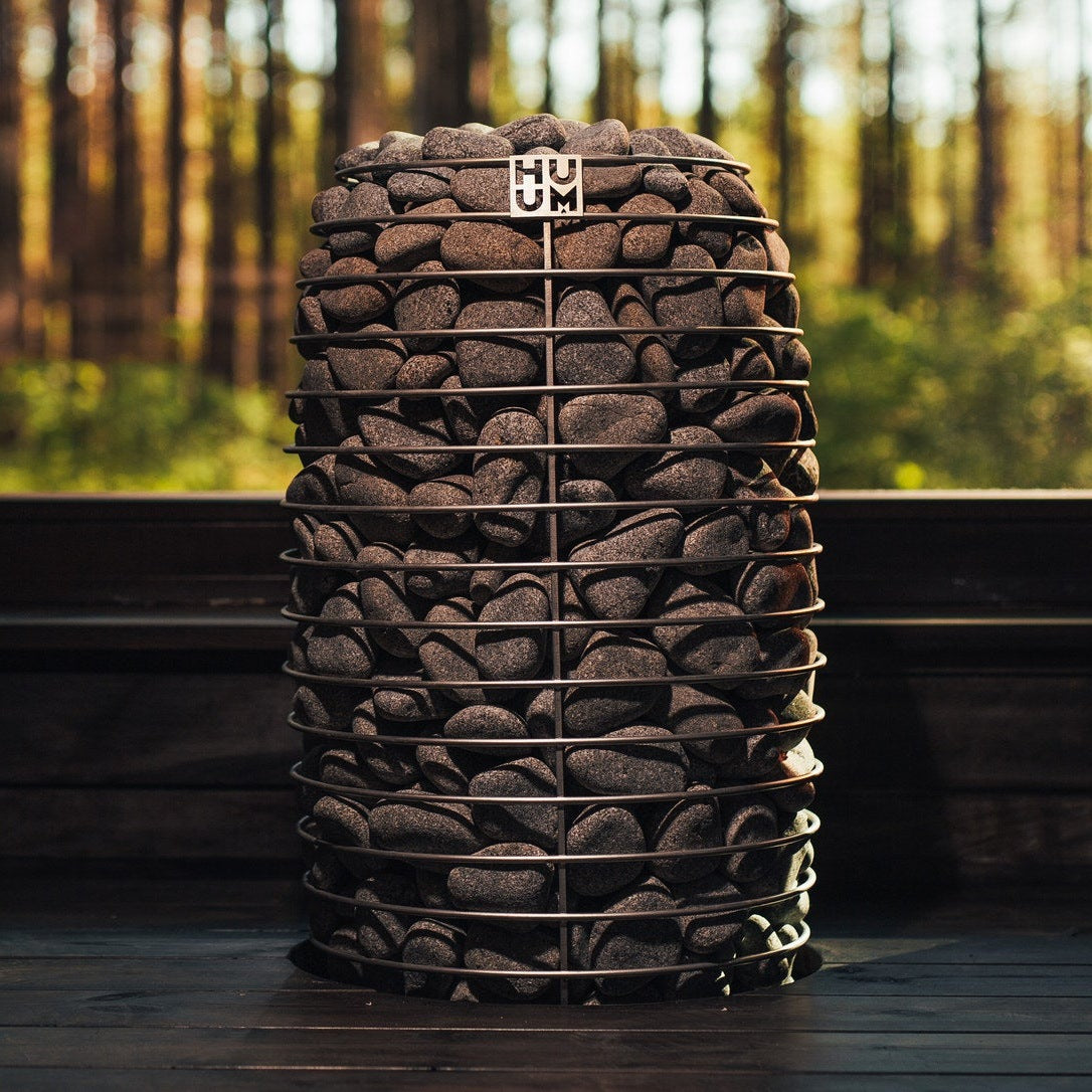 HUUM HIVE Mini 11 sauna heater with a forest view