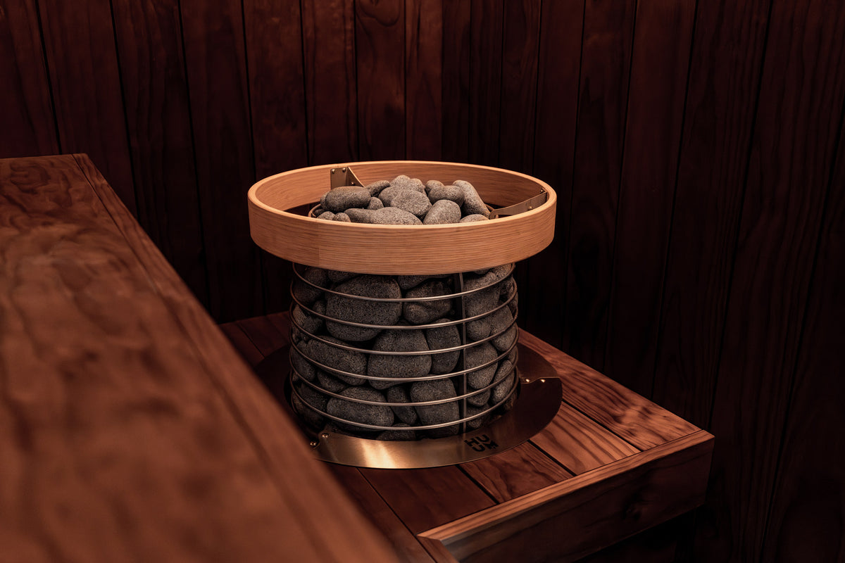 HUUM HIVE Mini with its safety rail in a sauna