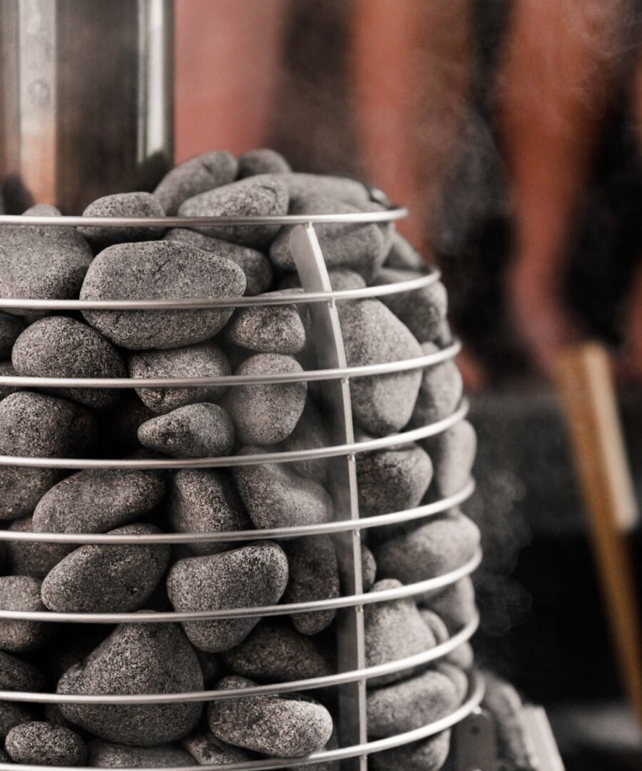 Sauna stones in the steel cage of the HUUM HIVE Wood 13 stove