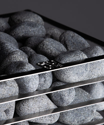 HUUM olivine diabase sauna stones loaded in the basket of a HUUM CLIFF heater