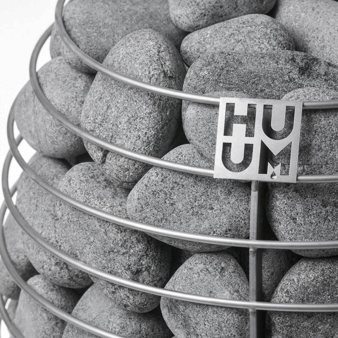 HUUM sauna stones in the open cage of a HUUM heater