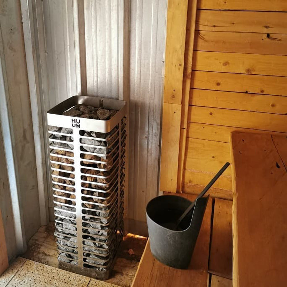 HUUM STEEL heater installed in the corner of a sauna