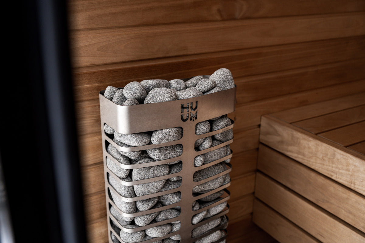 HUUM STEEL Mini in the corner of a wood sauna