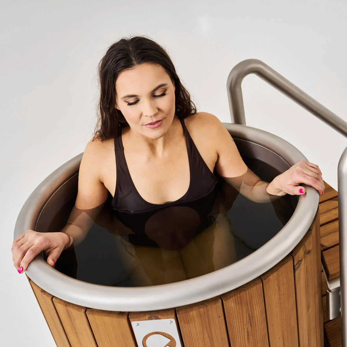 Icetubs IceBarrel Thermowood & Stainless Steel Cold Plunge Tub, one bather seated upright in the tub, water at chest height
