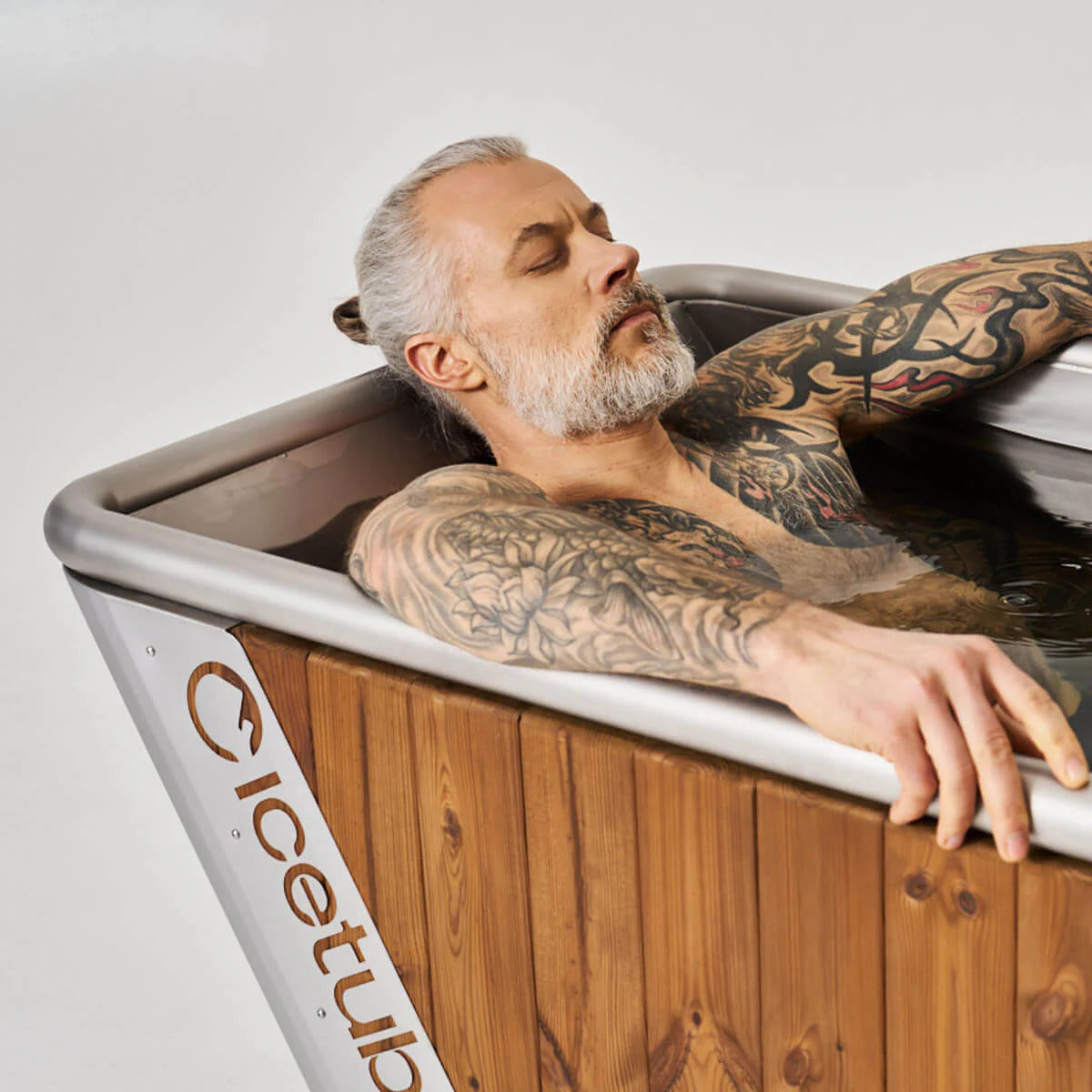 Icetubs IceBath Thermowood & Stainless Steel Cold Plunge Tub, bather reclined against the 60 degree backrest