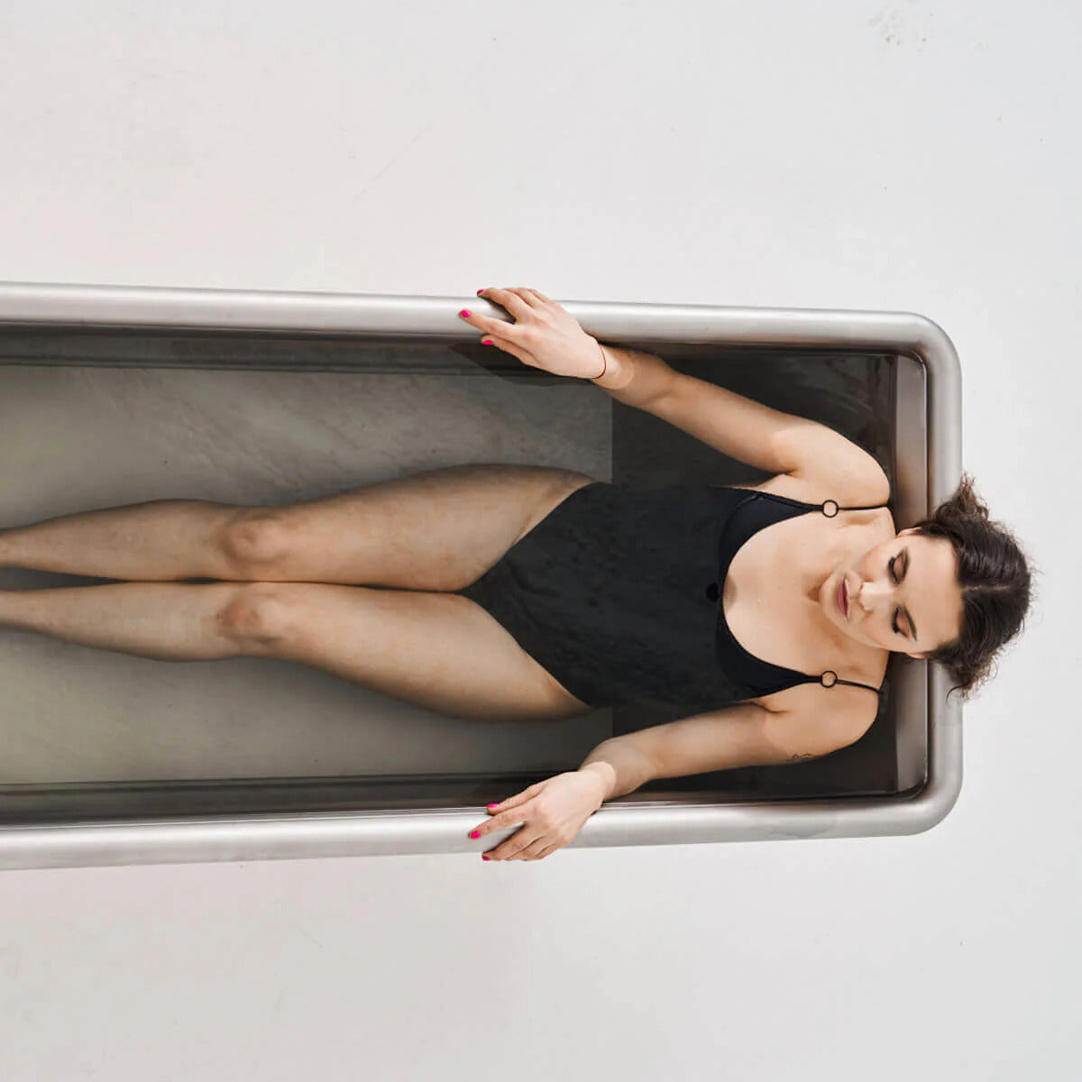 Icetubs IceBath Thermowood & Stainless Steel Cold Plunge Tub, overhead view of a bather lying full length in the stainless steel interior