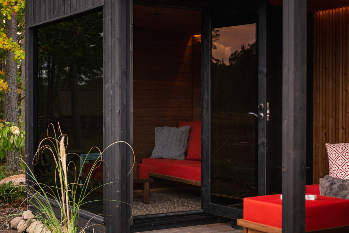 Nordic Misty Lounge seen from the garden, red seating under the overhang
