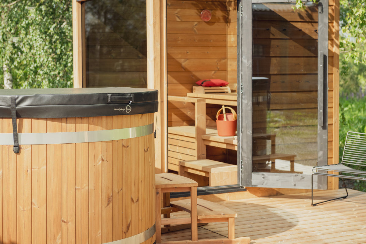 ThermaSol Nordic Dawn outdoor sauna cabin on a timber deck with the glass door open