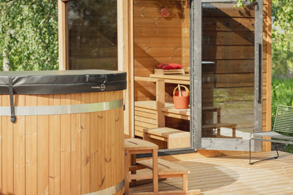 ThermaSol Nordic Dawn outdoor sauna cabin on a timber deck with the glass door open