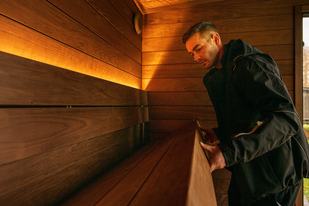 Cedar lined interior of the ThermaSol Nordic Misty, lit from the bench