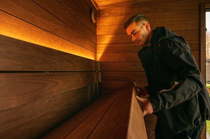 Cedar lined interior of the ThermaSol Nordic Misty, lit from the bench