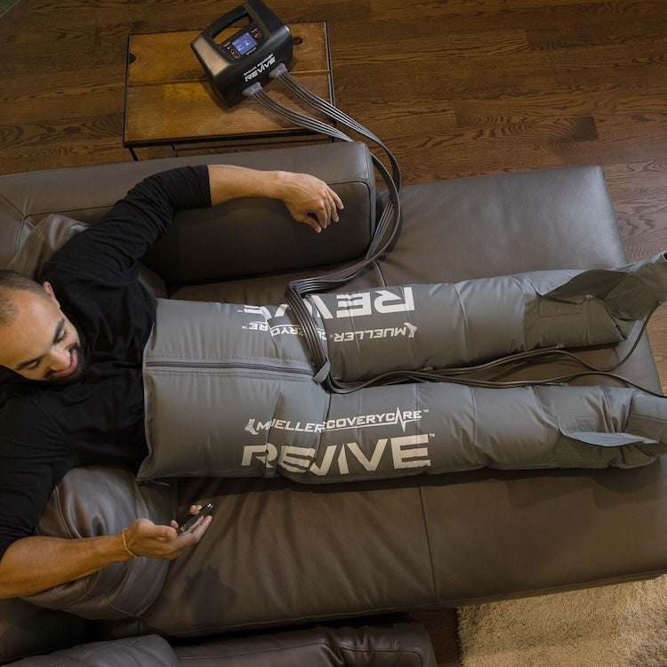 Mueller REVIVE Compression Pants overhead lifestyle view during recovery