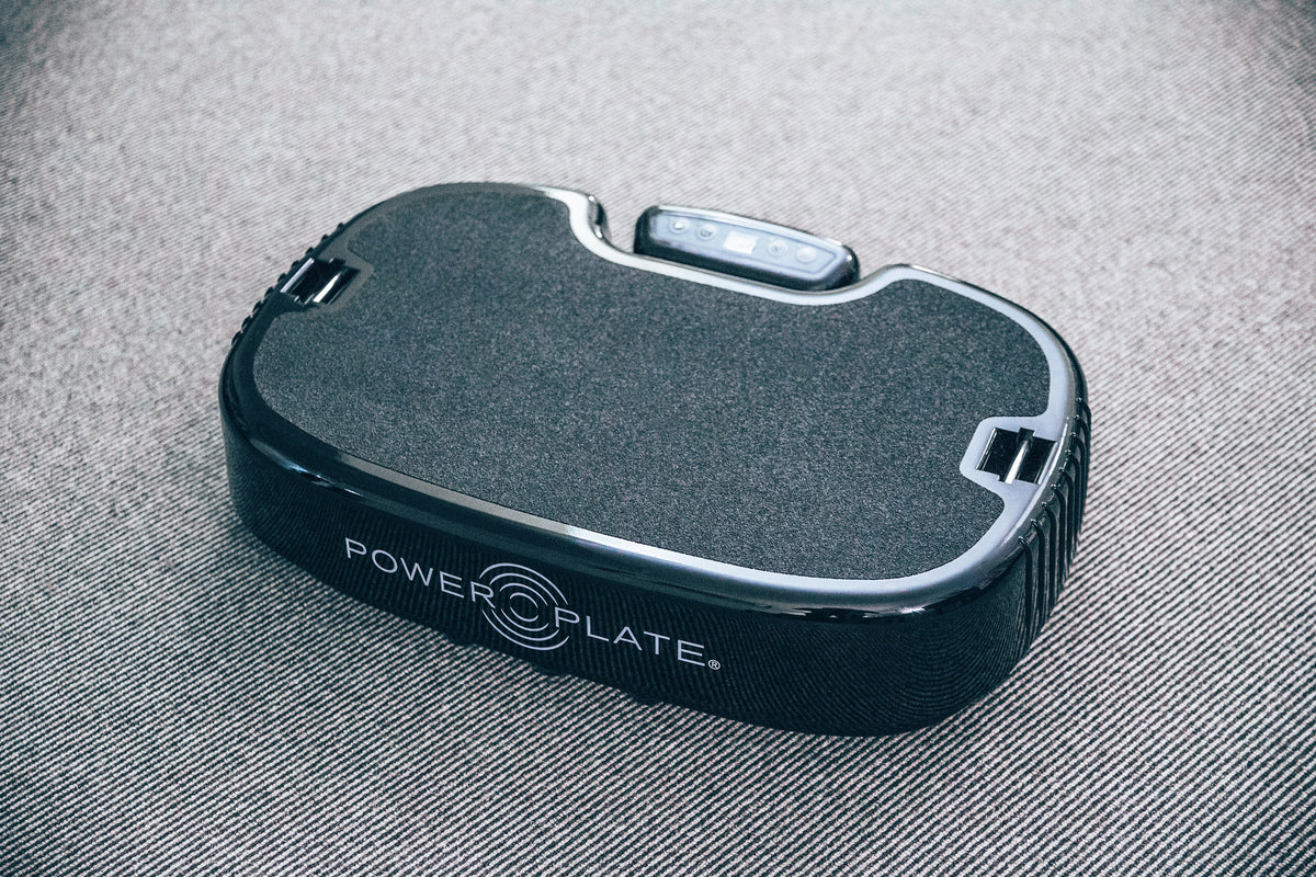 Personal Power Plate resting on a woven rug, seen from above