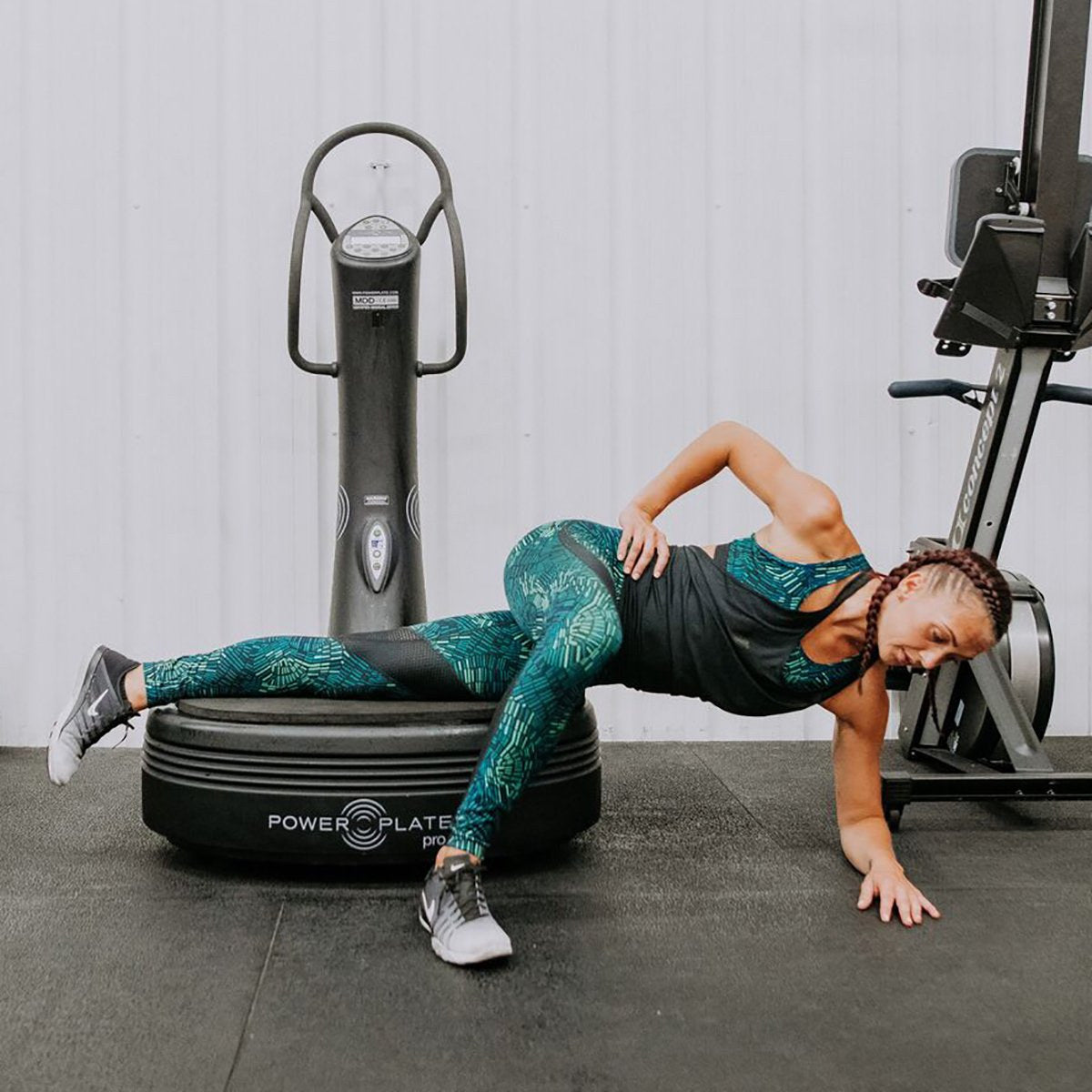 Woman doing a side plank variation with her legs on the Power Plate pro5 platform