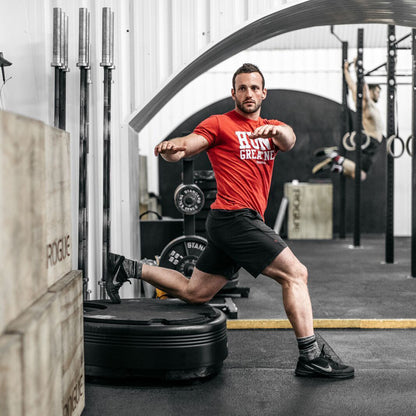Man in a lunge with his back foot on the Power Plate pro5HP in a gym