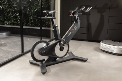 Power Plate REV in matte black standing in a home gym