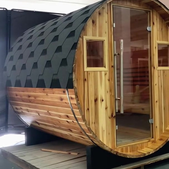 SunRay barrel sauna walkaround film in western red cedar: shingled roof, glass door and windows, then the heater and benches inside