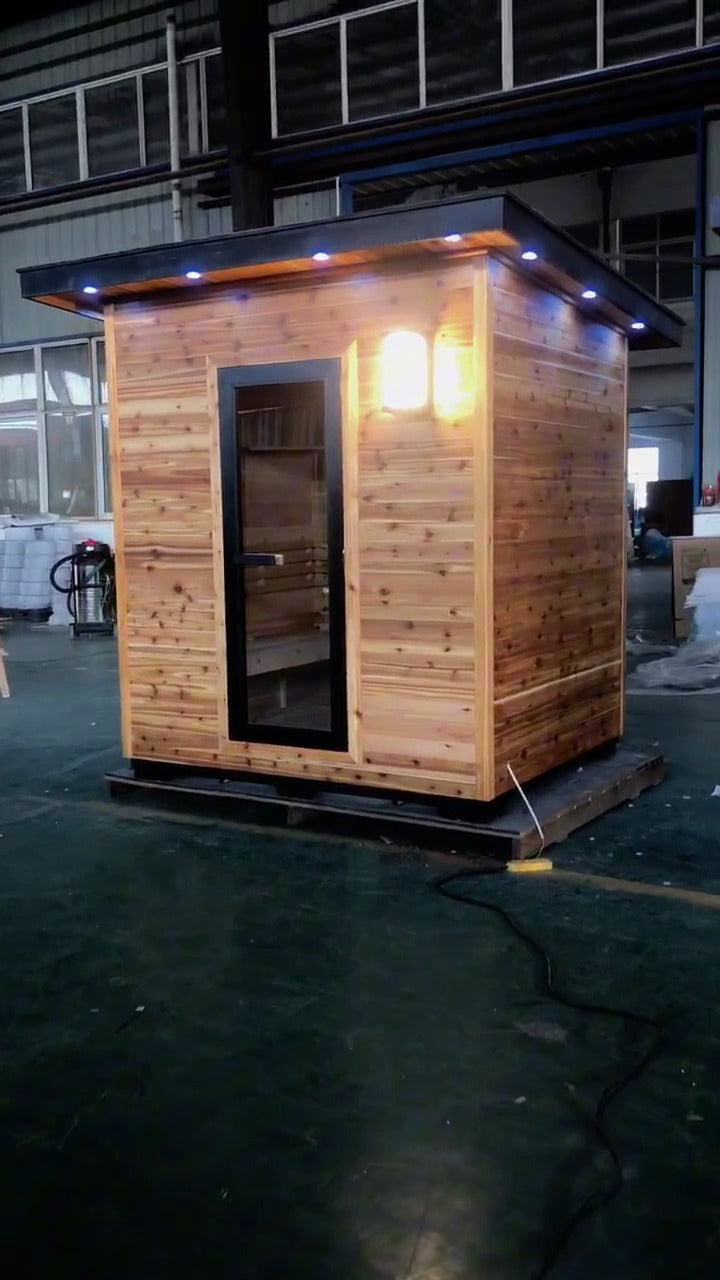 SunRay Denali outdoor sauna walkaround film: cedar cabin with a flat roof, black framed glass door and wall light, then the heater, benches and interior