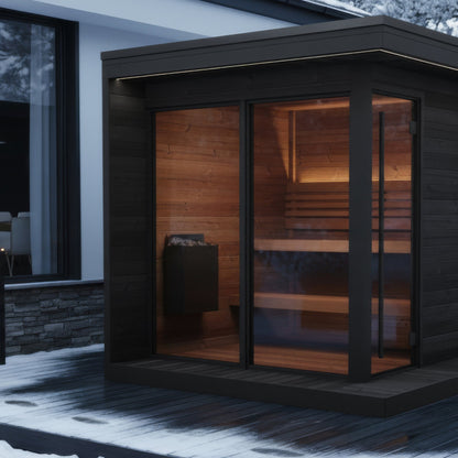 SaunaLife GL6 Garden Luxury 6-Person Outdoor Sauna Kit, black finish, in winter beside a glass house