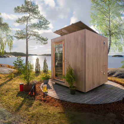 ThermaSol Solaris solar powered sauna cabin on a lakeside deck