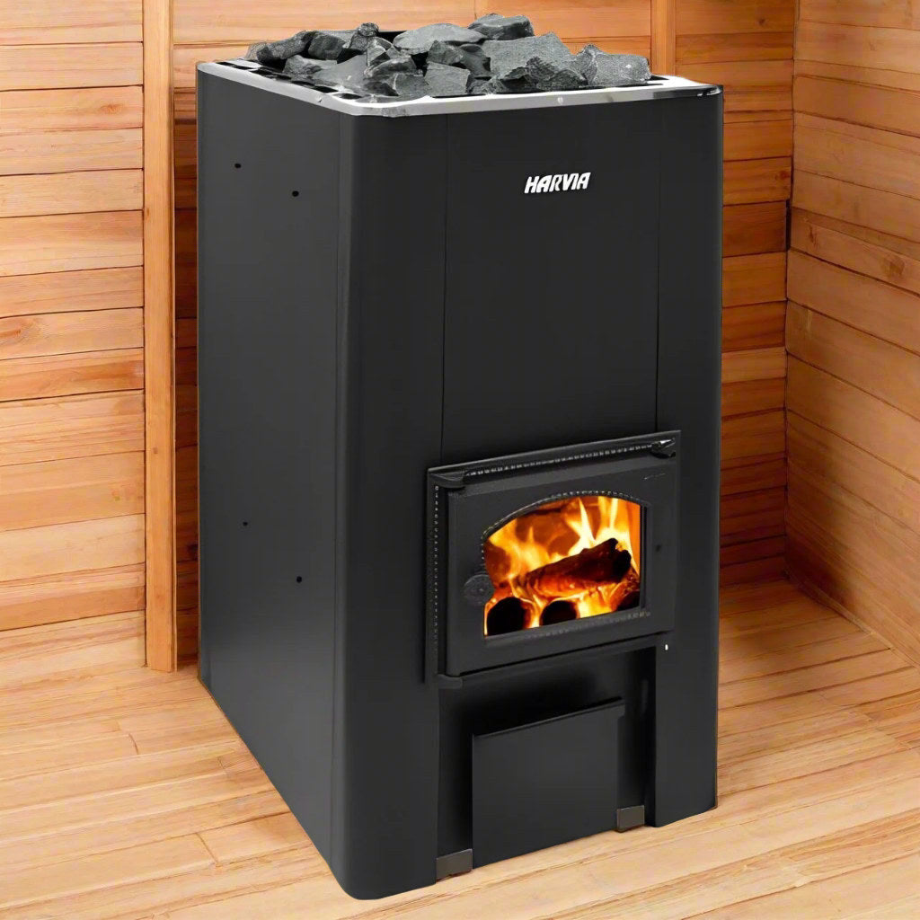 Harvia 50 wood-burning sauna stove with the firebox lit, in a timber sauna room