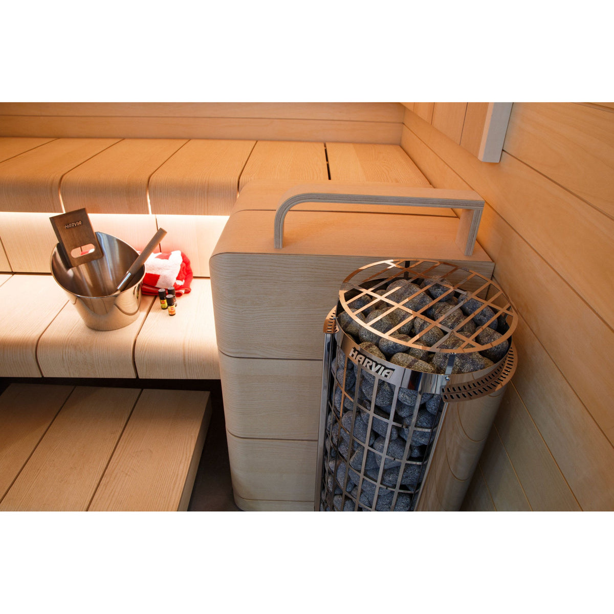 Harvia Cilindro pillar heater in a finished home sauna with bucket and ladle