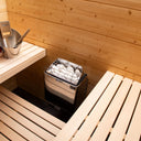 Harvia KIP steel electric sauna heater with built-in dial controls and stone rail, studio photo on white